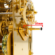 Close-up of a gold clock movement with a measurement label indicating 37mm.