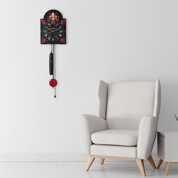 Black and red decorative wall clock hanging in white living room above white chair.