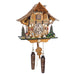 Intricate wooden cuckoo clock with pine trees, tractor detailing and boy figure  