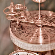 Close-up of a detailed Astrolabium clock mechanism with gears and astrological symbols.