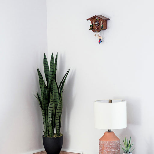 Traditional German cuckoo clock:  Annaliesse on white wall in bedroom scene.