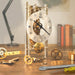 Mechanical Lakin clock kit with gears and tools on a wooden desk